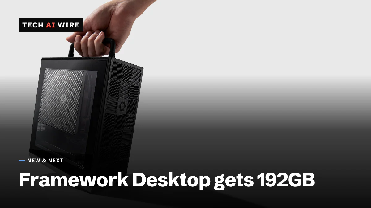 A hand lifting a small black Framework Desktop by its top handle, showing the perforated side panel and the patterned front with the Framework gear logo, against a light gray backdrop.