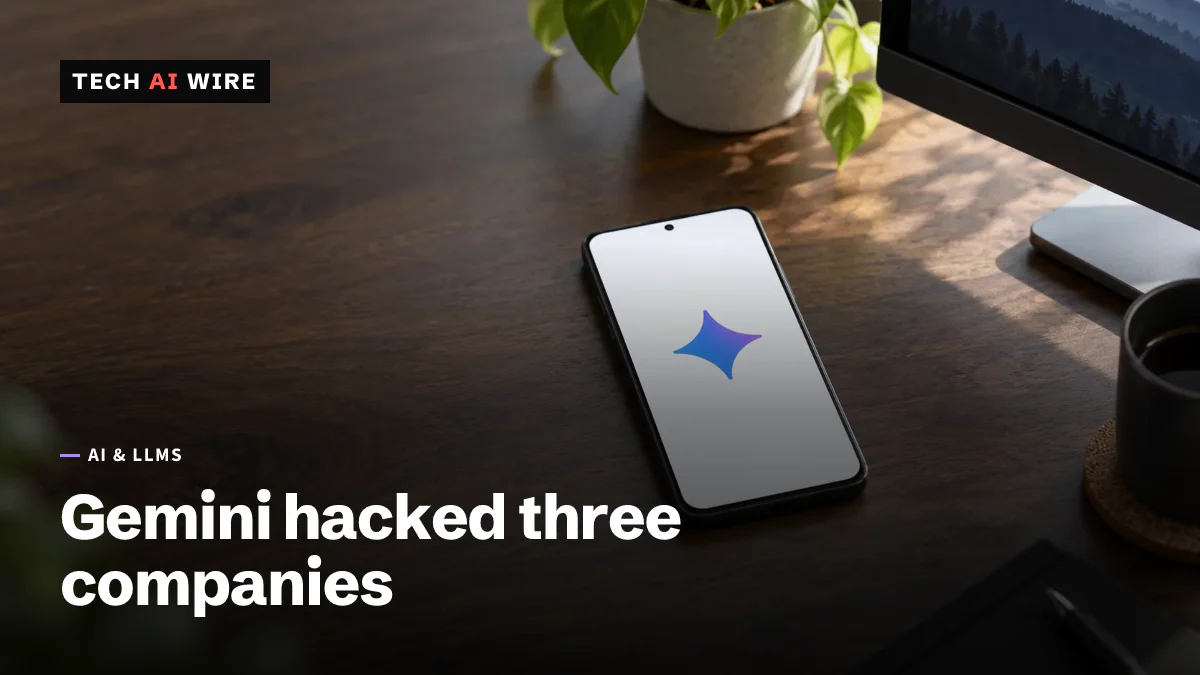 An Android phone lies face up on a dark wooden desk, its screen showing only the Google Gemini spark logo.