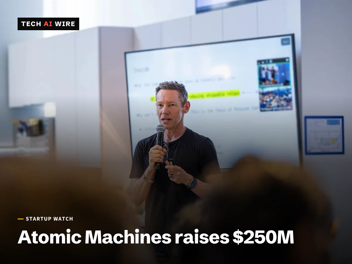 Atomic Machines founder and CEO Jeff Holden speaks into a microphone in front of a presentation screen.