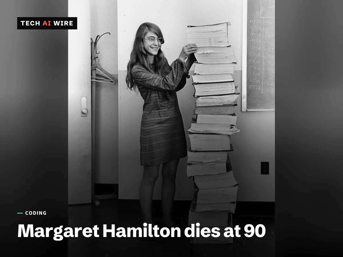 Margaret Hamilton in 1969, smiling beside a stack of printed listings of the Apollo flight software taller than she is.