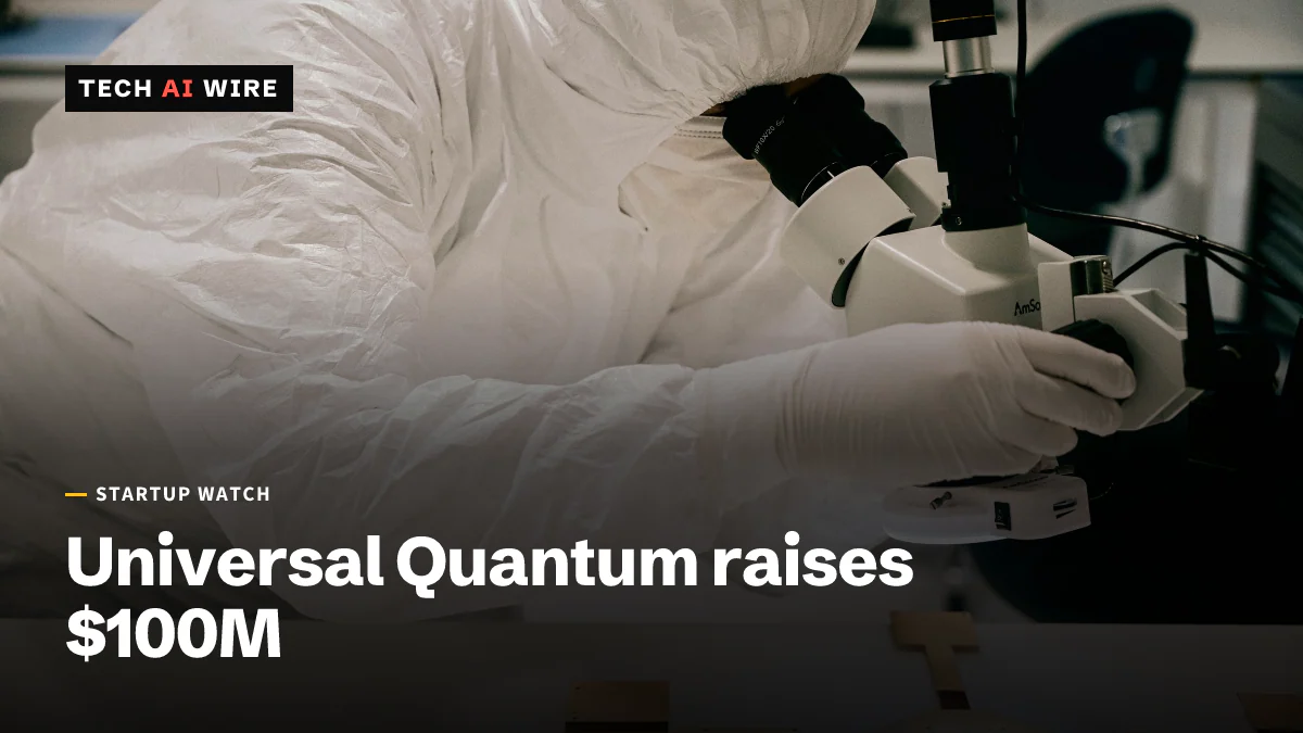 A researcher in a white cleanroom suit looks through a microscope at a chip mounted on a gold carrier board.
